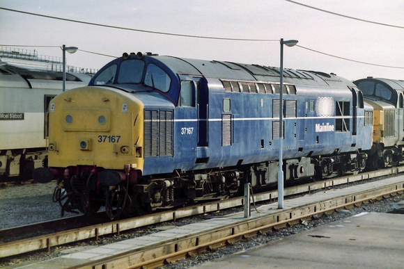 37167 at an unknown location in Mainline Blue livery.