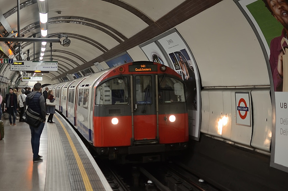 The Piccadilly Line at Earl's Court sees a train of 1973 stock arrive on a service to Cockfosters.